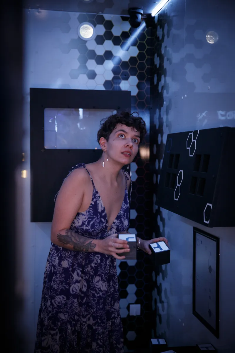 Participante intriguée dans un escape game avec décor futuriste